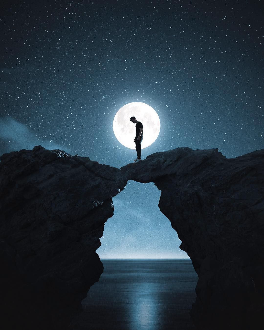 An illustration of a dejected person standing between two rocks above the sea with the moon and stars in the background